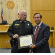 State Attorney Brian Haas honors Polk Sheriff's Detective Ronald Brackley.
