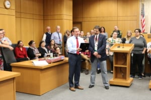 State Attorney Brian Haas presents Pete Mislovic with a plaque during a retirement party..